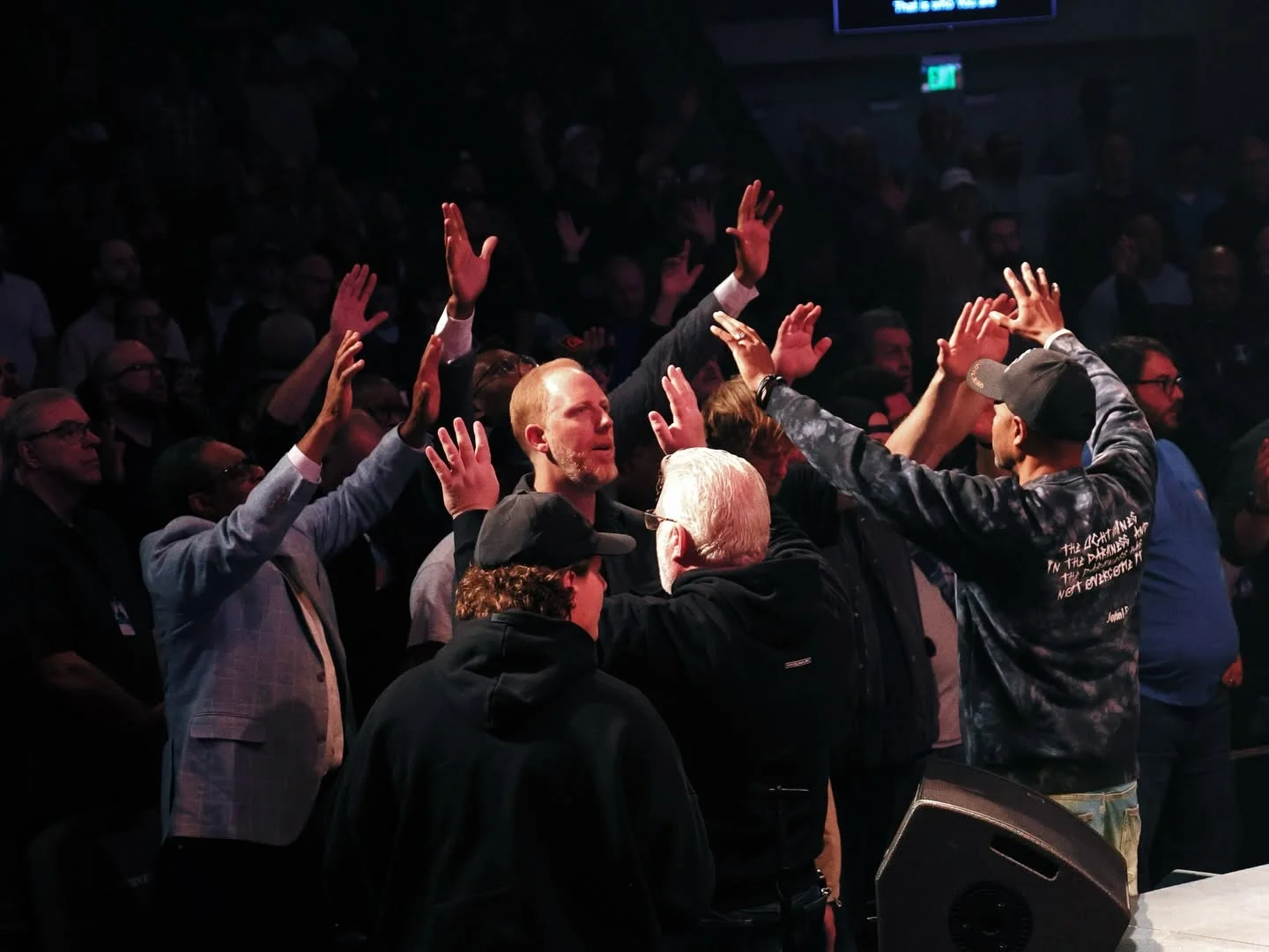 Men encouraging each other in prayer at Invincible 2026