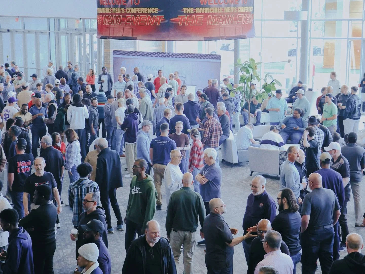 Men catching up in the Brightmoor lobby during Invincible 2026